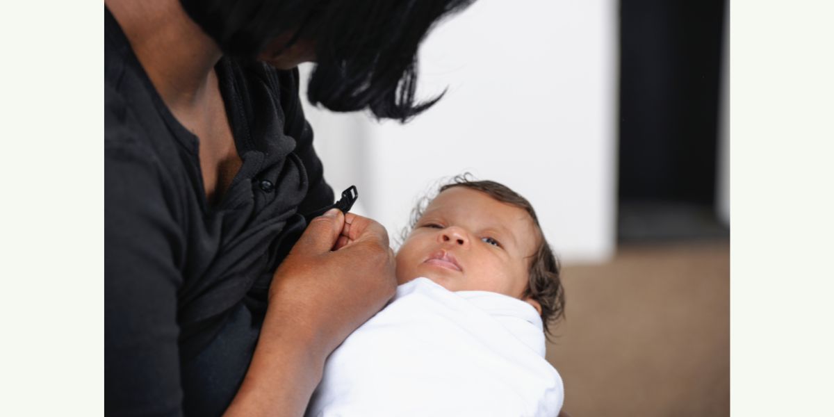 woman nursing new born baby